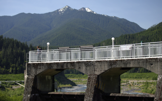 dam in the pacific northwest with mountain backdrop