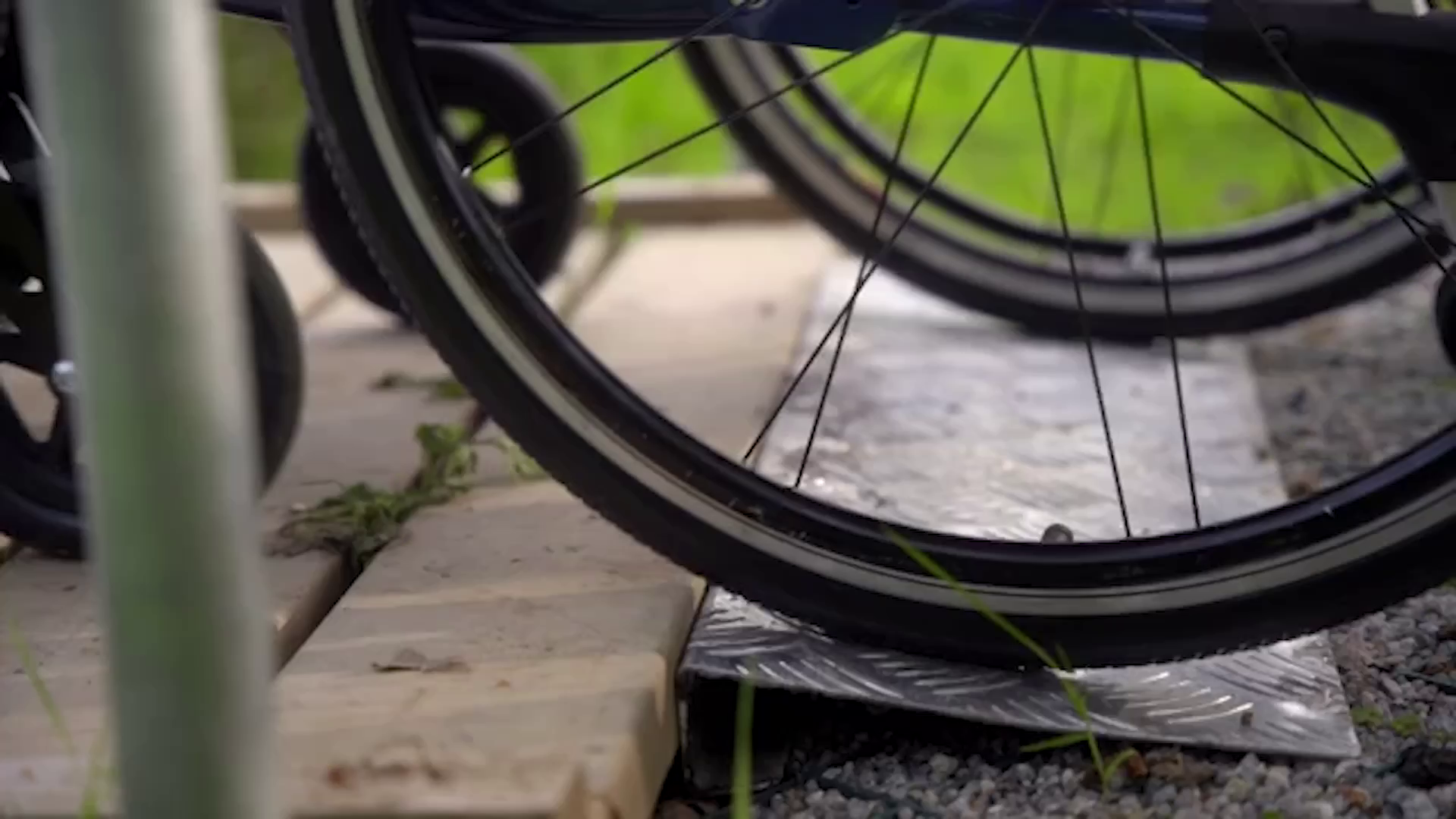 a wheelchair using an outdoor walkway