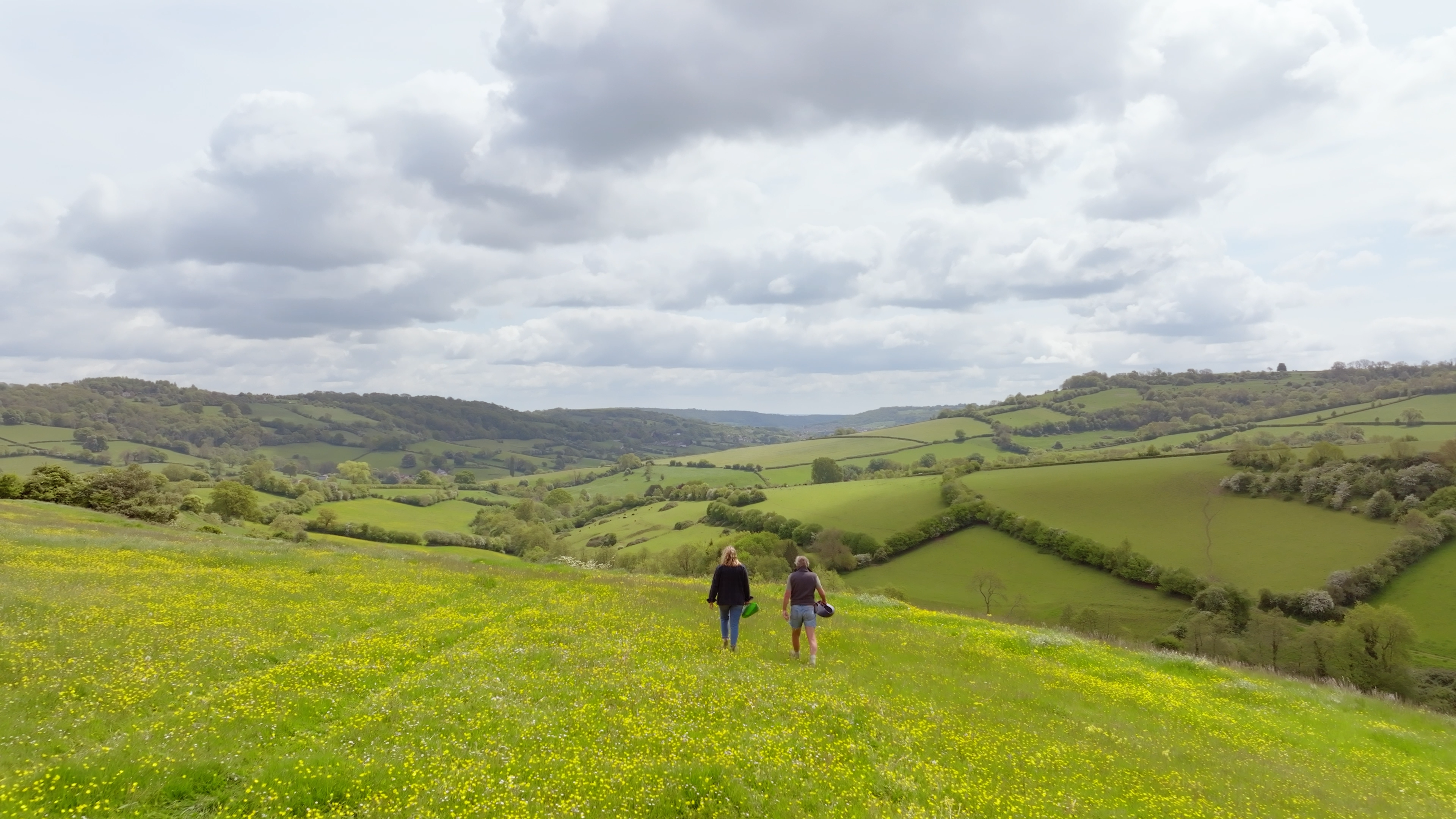 An English pastoral landscape with green grass and rolling hills.