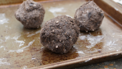 Three seed balls sit on a baking tray