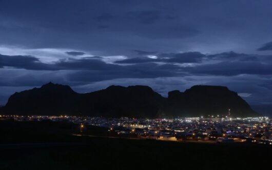 A town in Iceland lit up by artificial light.