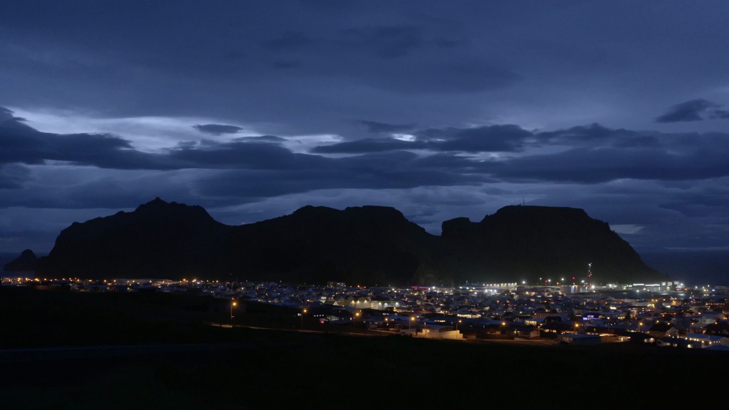 A town in Iceland lit up by artificial light.